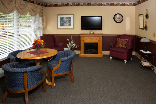 A cozy living room with a television and fireplace, perfect for relaxation.
