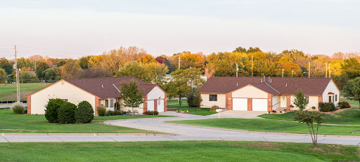 A serene suburban neighborhood in autumn, showcasing cozy homes surrounded by colorful trees.