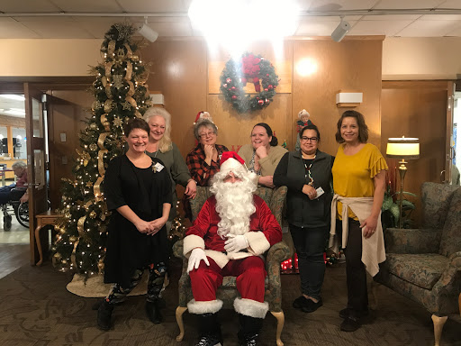 A joyful holiday gathering featuring Santa Claus and friends celebrating the festive season.