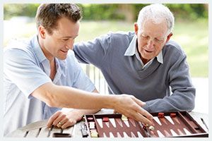 Two people enjoying a game of backgammon together.