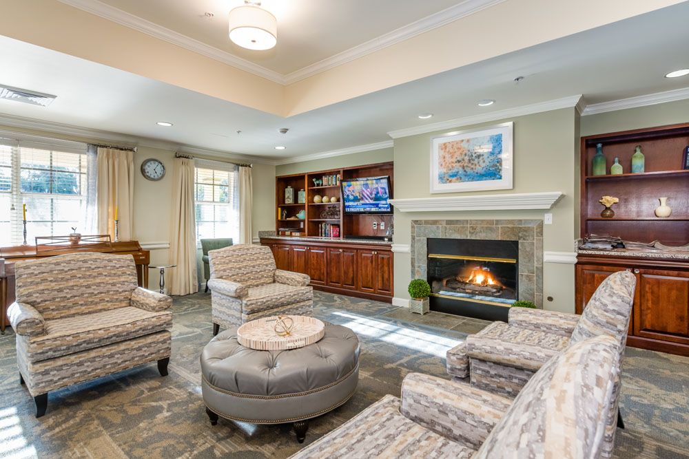 A cozy living room with a fireplace, comfortable seating, and elegant decor.