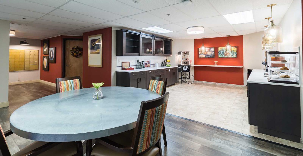 A modern kitchen and dining area with stylish furniture and cabinetry.