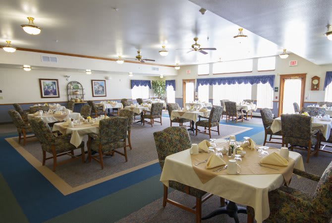 A cozy dining area with neatly arranged tables and chairs, set for service.