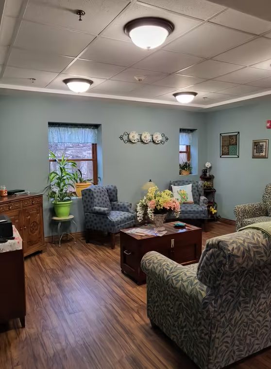 A cozy living room with comfortable seating arrangements, indoor plants, and elegant decor.