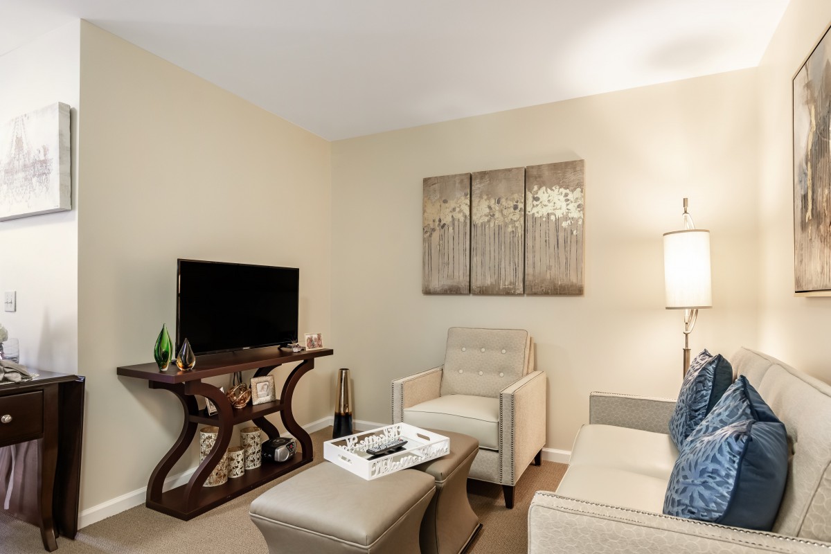 A cozy living room with modern furniture and neutral tones.