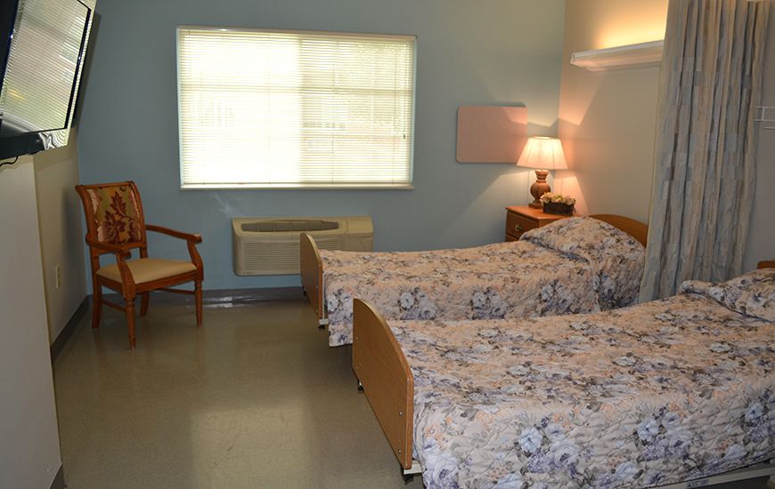 A cozy bedroom with twin beds and soft lighting.