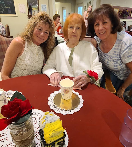 A joyful family celebration with cake and flowers.