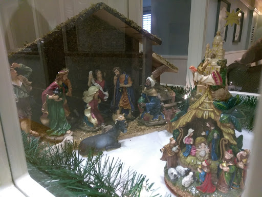 A beautifully arranged nativity scene showcasing various figurines representing the Christmas story.