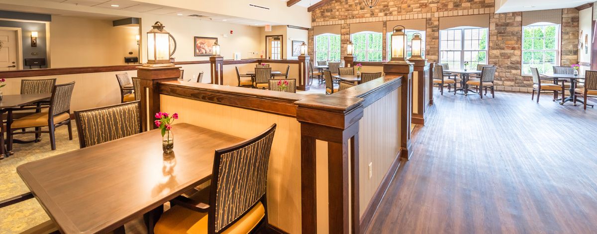 A cozy restaurant interior with wooden furniture and warm lighting.