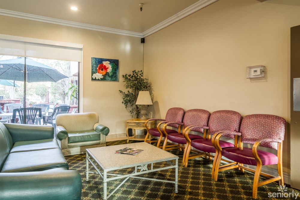 A cozy waiting room with seating, a coffee table, and decor.