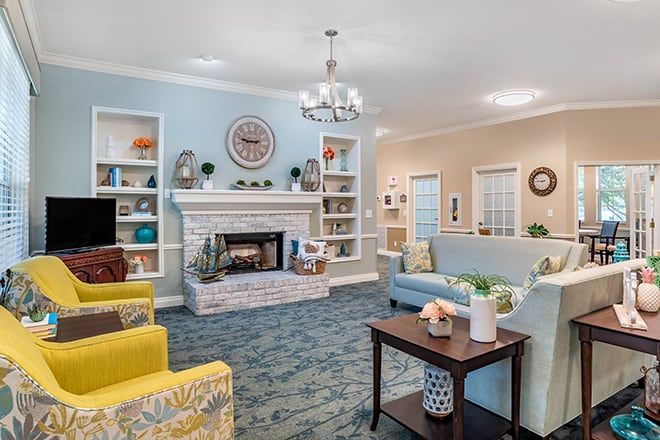 A cozy living room with a fireplace and comfortable seating.
