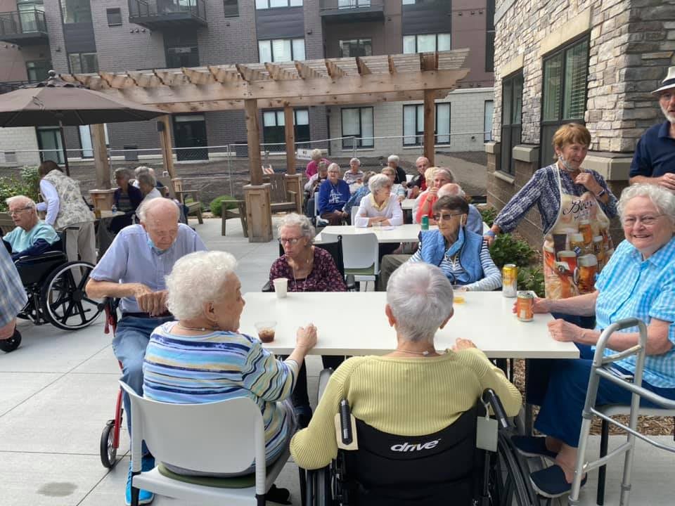 Elderly individuals enjoying an outdoor gathering at a communal space.