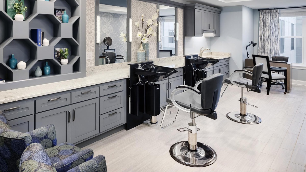 A modern hair salon with stylish barber chairs and sleek interior design.