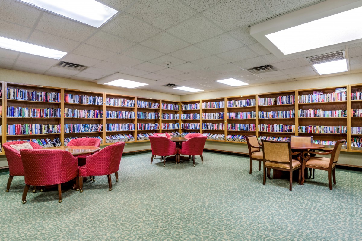 A cozy library reading area with bookshelves and comfortable seating.