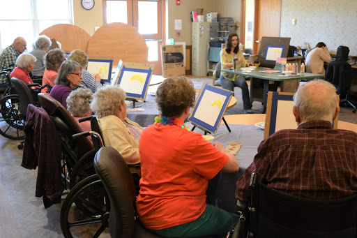 Elderly individuals engaged in a technology session at a community center.