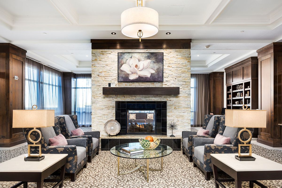 A stylish and modern living room with a central fireplace surrounded by comfortable seating and elegant decor.