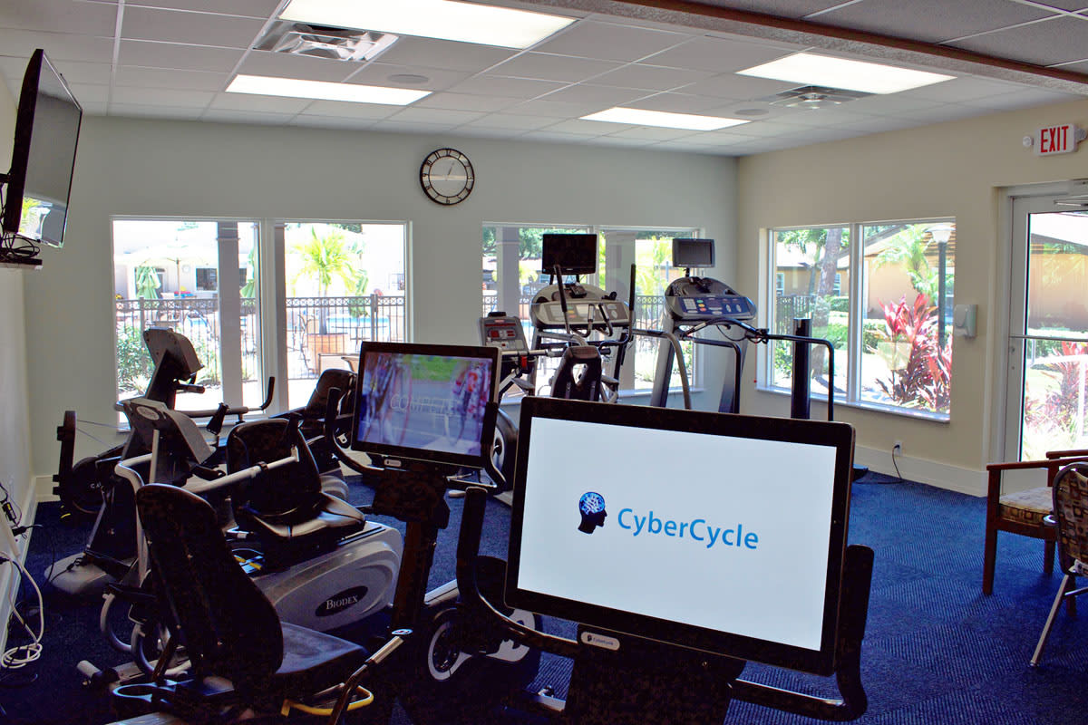 Indoor gym featuring CyberCycle exercise equipment.