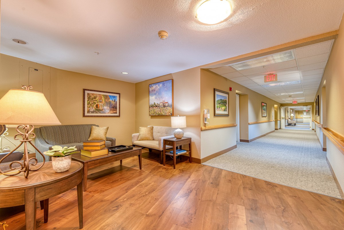 A cozy hallway with a lounge area featuring comfortable seating and modern decor.