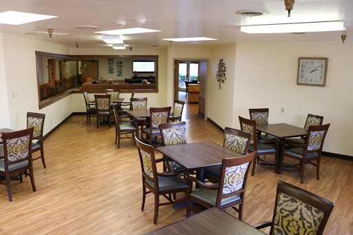 A spacious dining area with wooden tables and chairs, designed for community gatherings.