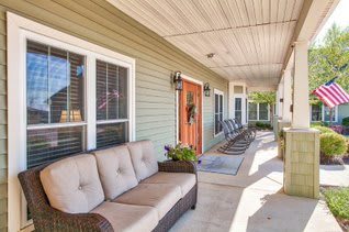 A cozy porch with comfortable seating and decorative elements.