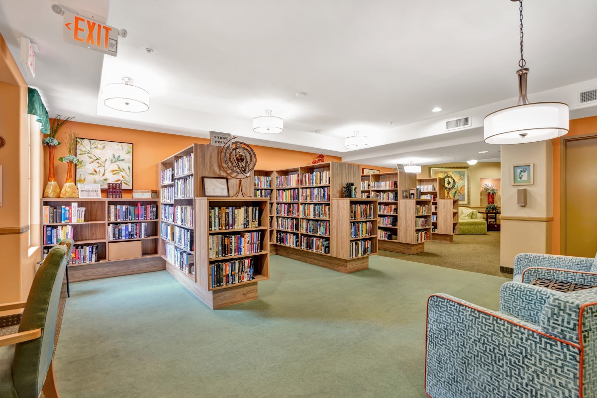 A cozy library interior with rows of bookshelves and a welcoming atmosphere.