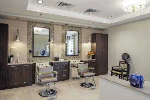 A modern hair salon interior with styling chairs and mirrors.