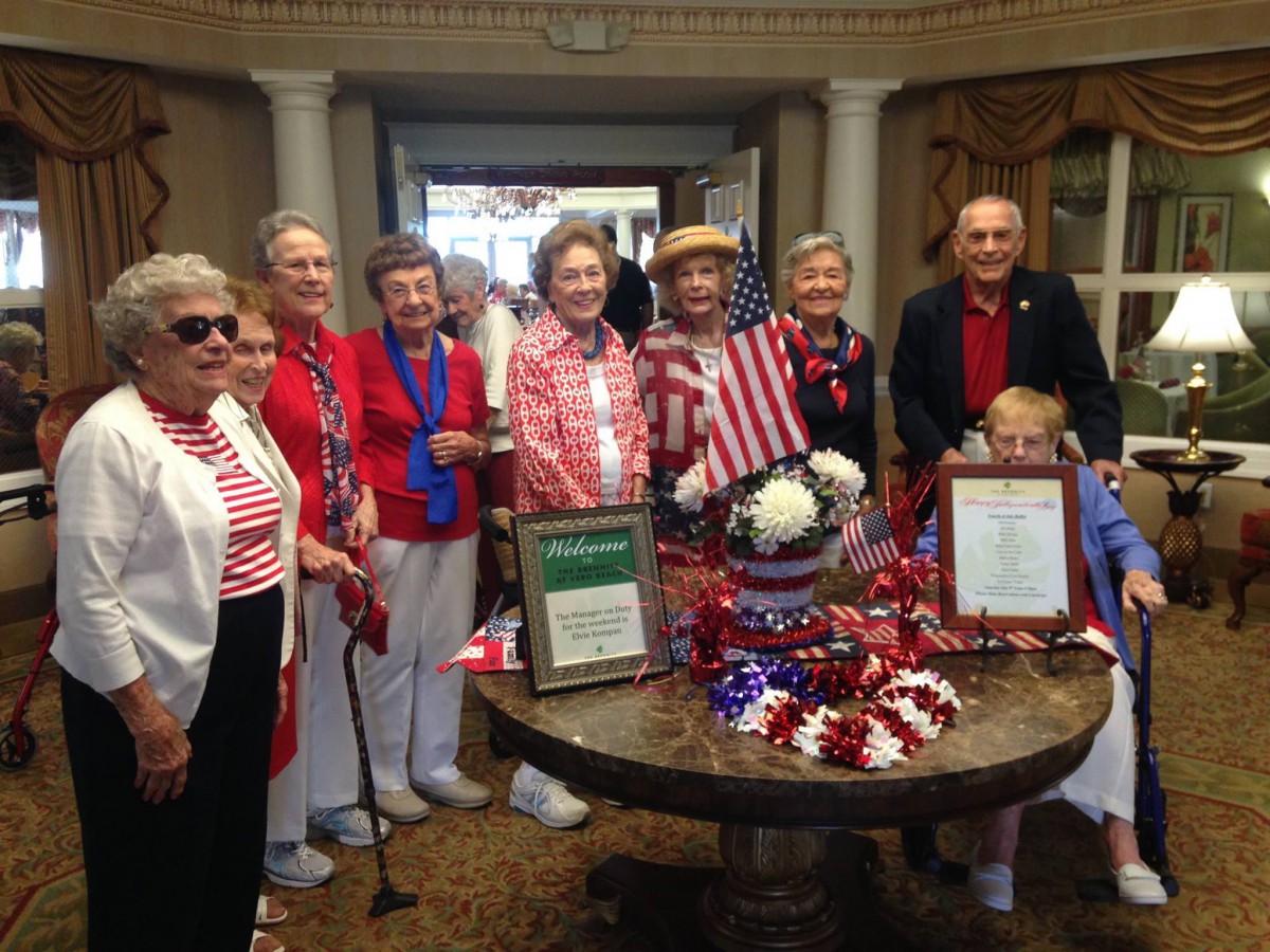 A group of seniors celebrate with a patriotic theme, dressed in red, white, and blue.