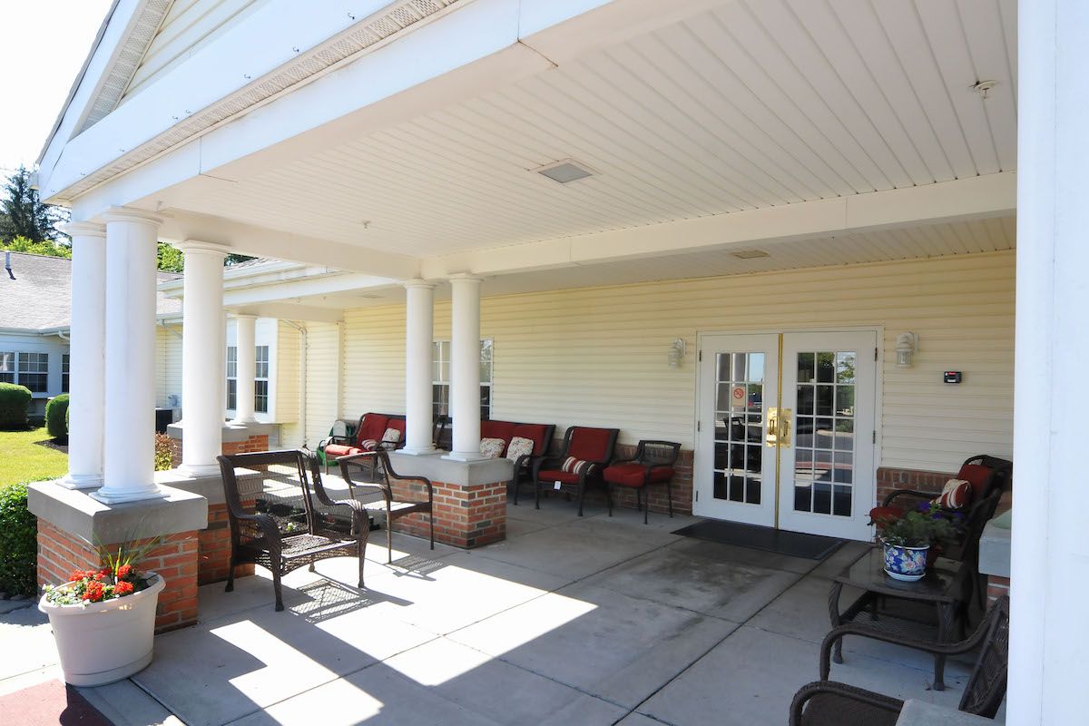 An inviting outdoor patio area with comfortable seating and tables, perfect for relaxation.
