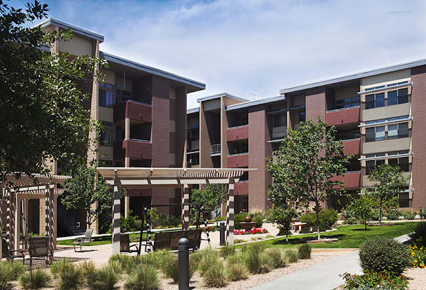 A modern residential apartment complex with landscaped outdoor areas.