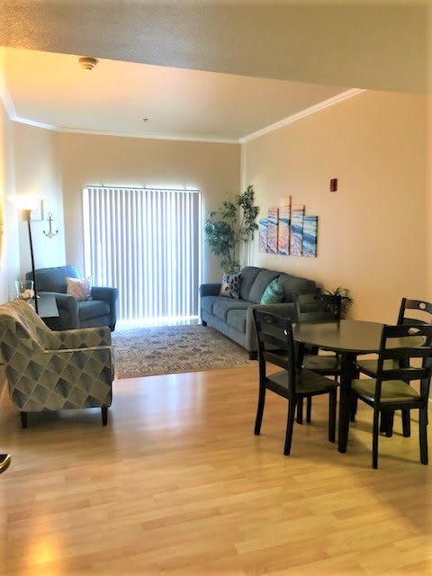 A cozy living and dining area with comfortable seating, a dining table, and tasteful decor.