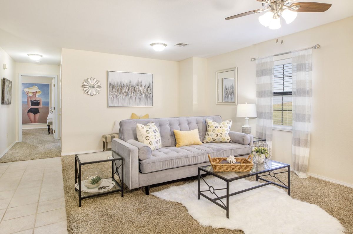 A cozy and modern living room with a gray sofa, stylish coffee table, and decorative wall art.