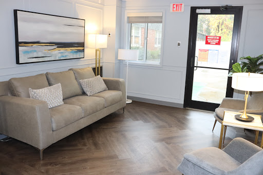 A cozy living room area featuring a comfortable sofa, contemporary art, and stylish lighting.