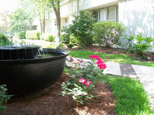 A serene garden showcasing vibrant flowers and a peaceful fountain.
