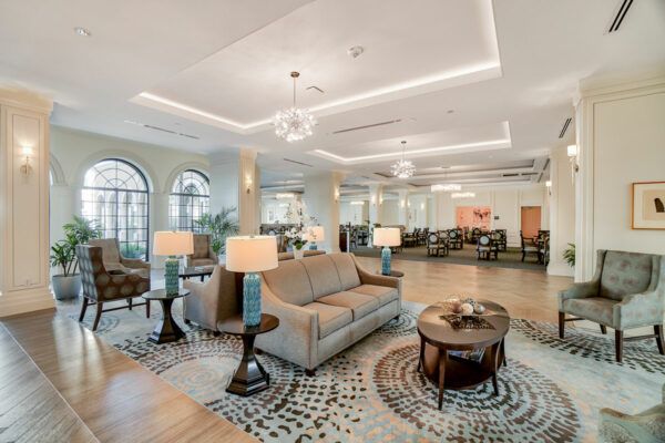 A spacious and elegantly decorated lobby featuring modern furniture and sophisticated lighting.
