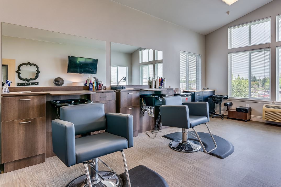 Modern salon interior with styling chairs and mirrors.
