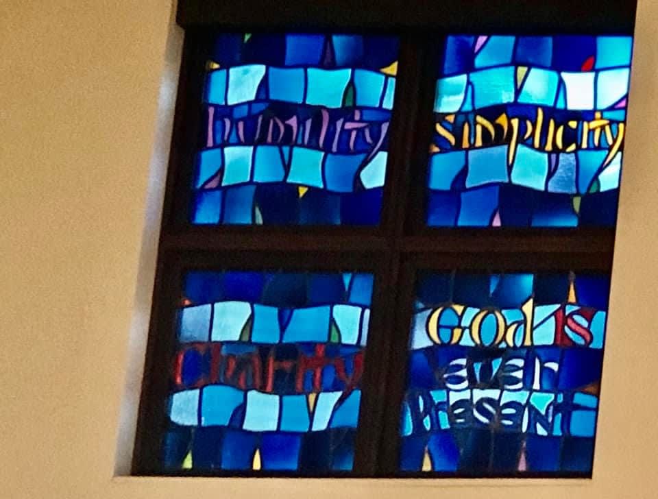A stained glass window featuring blue hues and abstract designs.