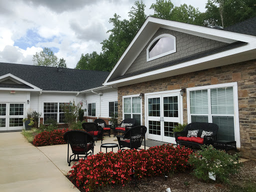 A welcoming outdoor seating area surrounded by vibrant flowers, perfect for relaxation.