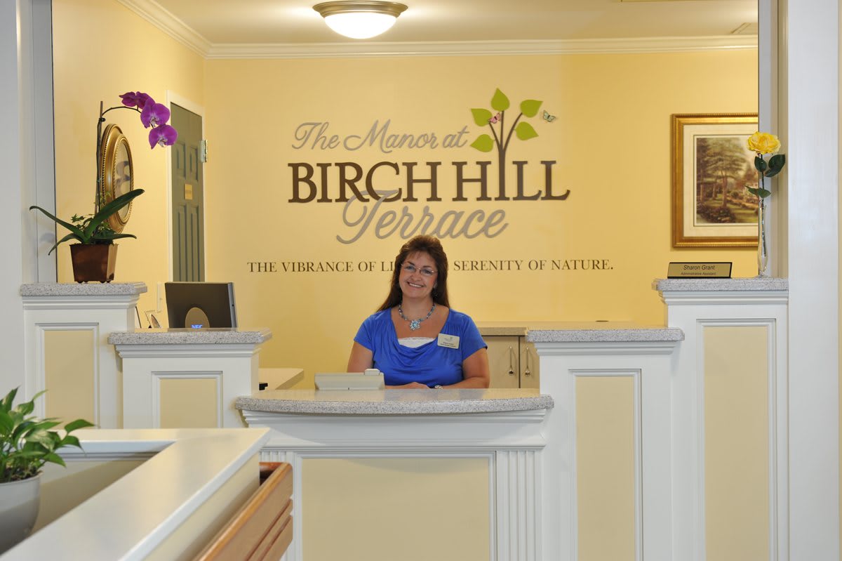 A receptionist at the Birch Hill Terrace front desk.