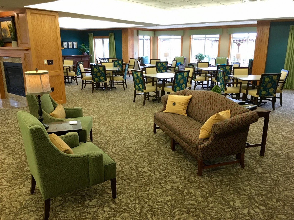 A cozy lounge area with comfortable seating and tables.
