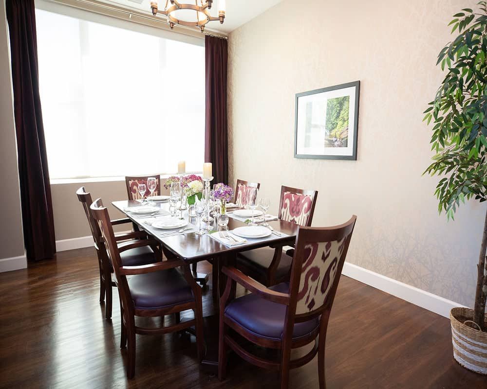 A stylish dining room with a set table and elegant decor.