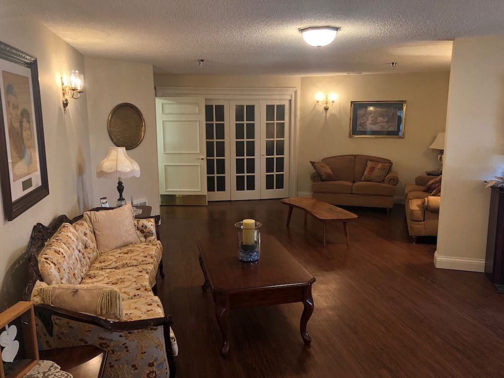 A cozy living room with classic furniture and hardwood flooring.
