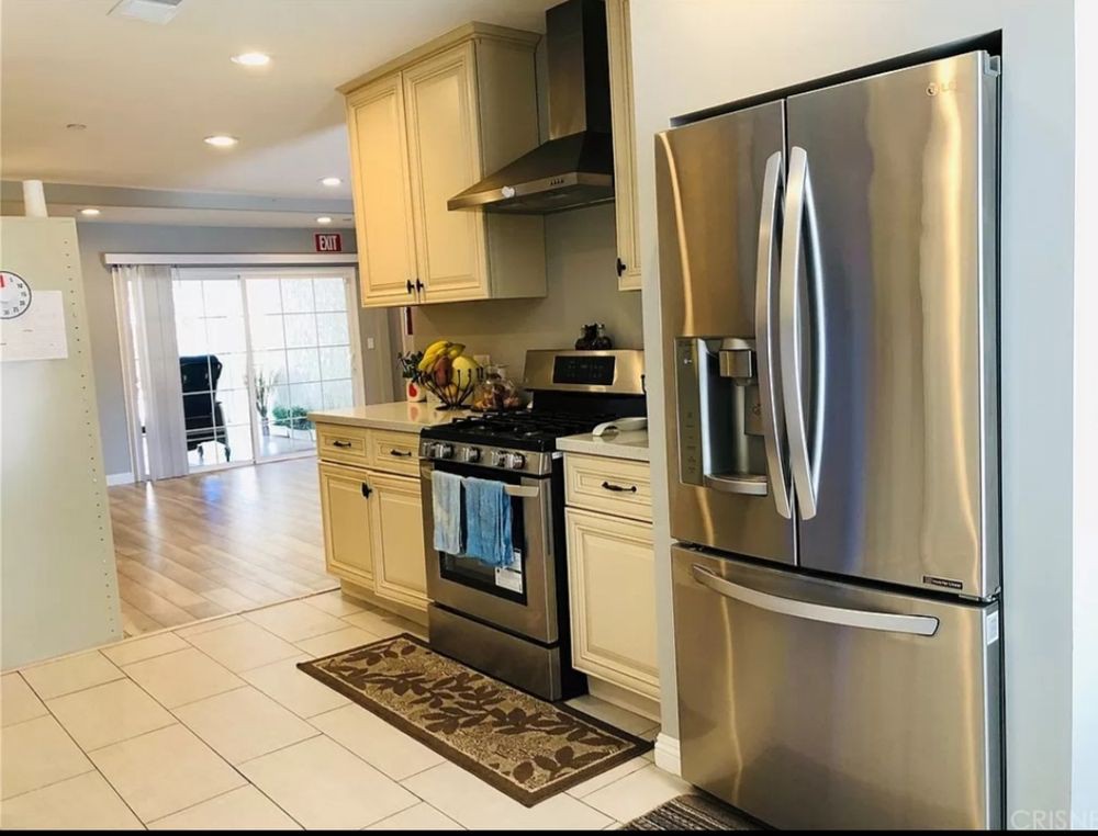 A modern kitchen with stainless steel appliances and light-colored cabinetry.