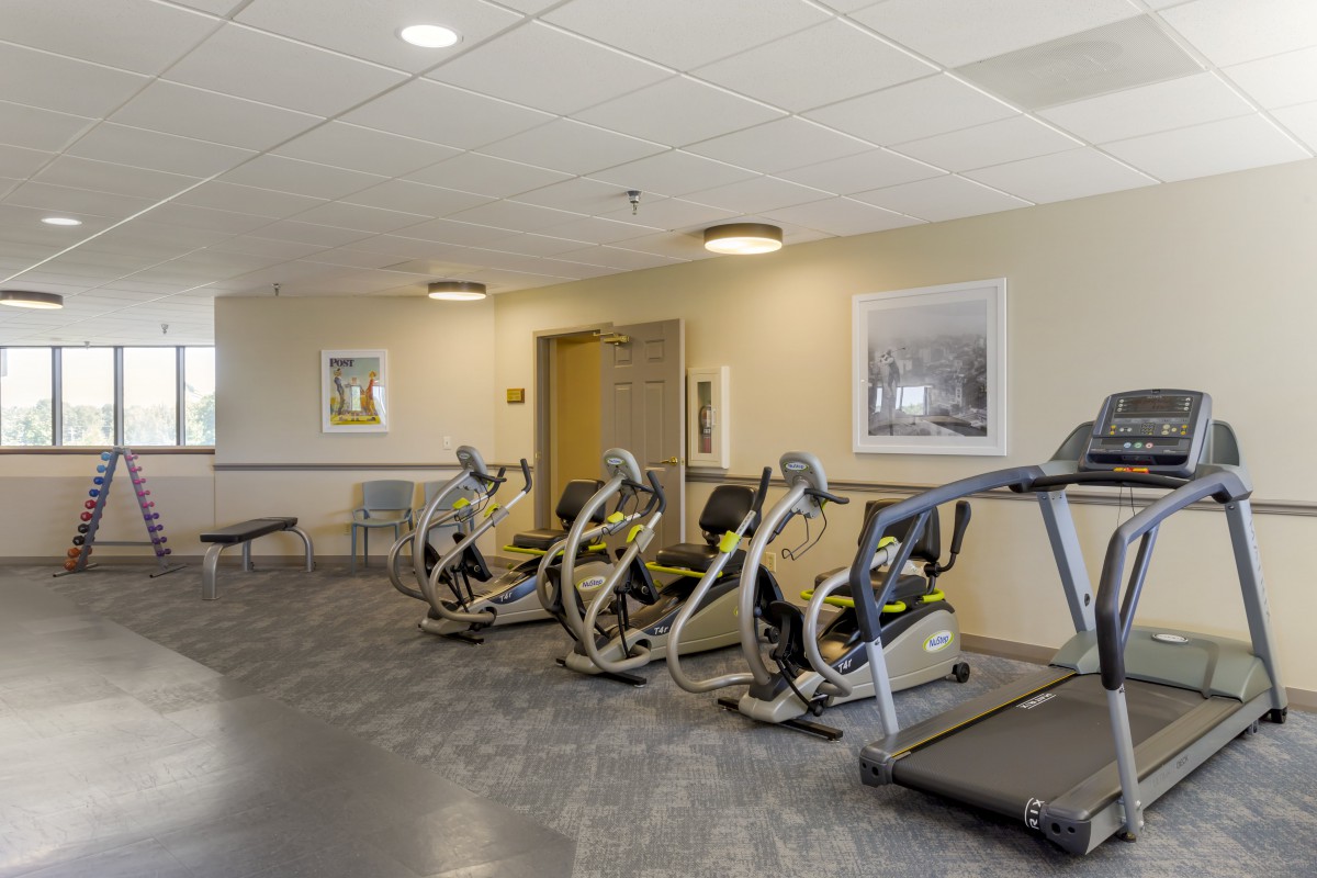 A well-equipped gym with treadmills and stationary bikes for workouts.