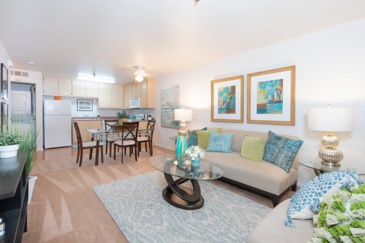 A modern open-concept living and dining area featuring stylish furniture and bright decor.