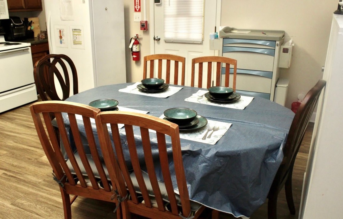 A dining table set with plates and utensils for four people.