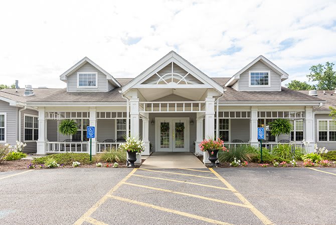 A traditional-style building with a symmetrical entrance and surrounding greenery.