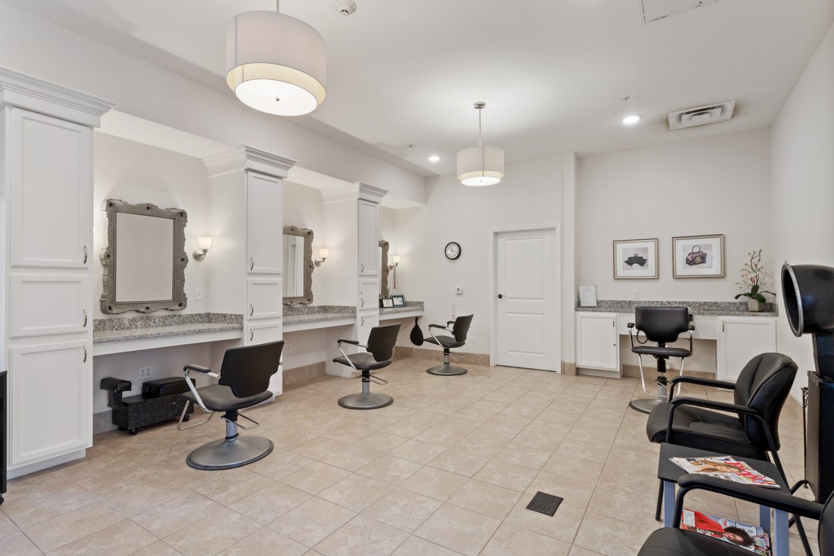 A modern hair salon interior with styling chairs and mirrors.