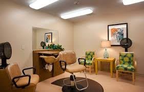 A modern salon interior with chairs and a large mirror.