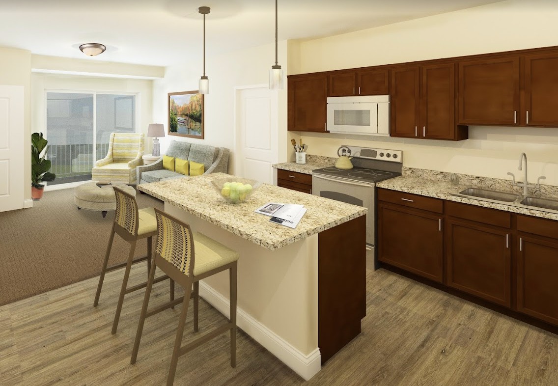 A modern open floor plan kitchen and living room with wooden flooring and contemporary furnishings.