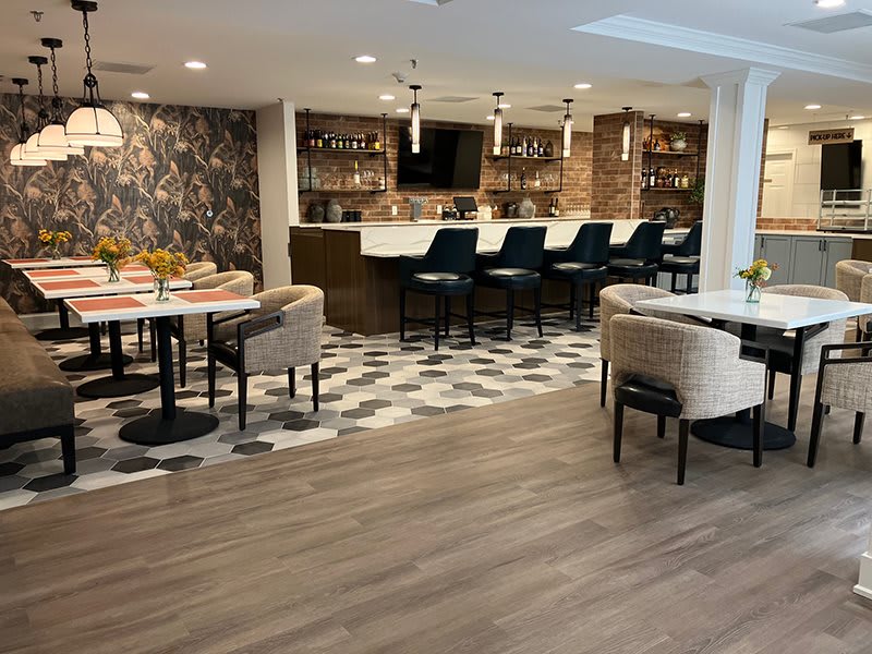 A modern restaurant interior featuring a stylish bar and comfortable seating areas.